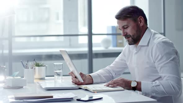 Mid-Aged Businessman Making Video Call on Digital Tablet alt