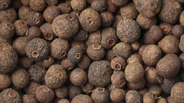 Dried whole allspice berries close up full frame as a background  alt