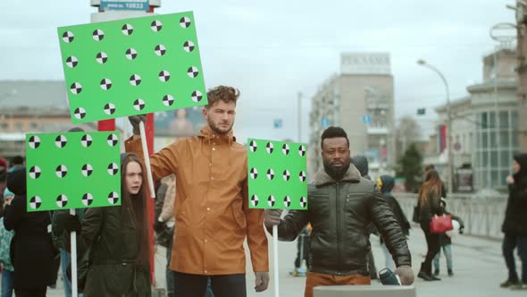 Political Activists of Various Peoples at Rally with Greenscreen Mockup Placards