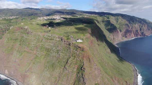 Flying over Ponta do Pargo lighthouse, built on a cliff, Madeira, Portugal alt