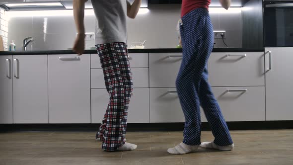 Legs of Happy Couple Dancing in Kitchen alt
