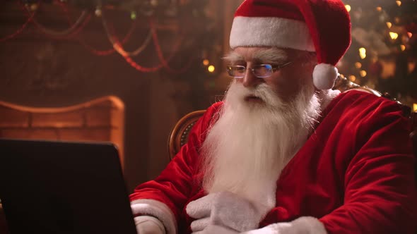 Santa Claus Warm Atmosphere in Living Room Using Laptop alt