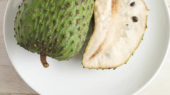 Closeup of Green Soursop Graviola, Exotic, Tropical Fruit Guanabana on Plate alt
