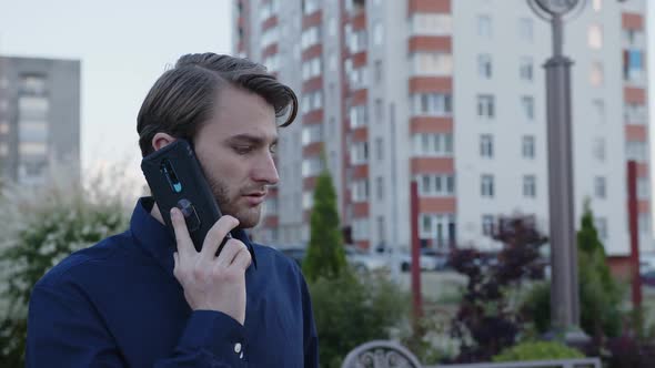 Bearded Man Talks on His Black Phone alt