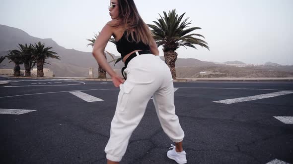 Active Attractive Girl with Beautiful Body Dancing Twerk at the Resort Tropical Area alt