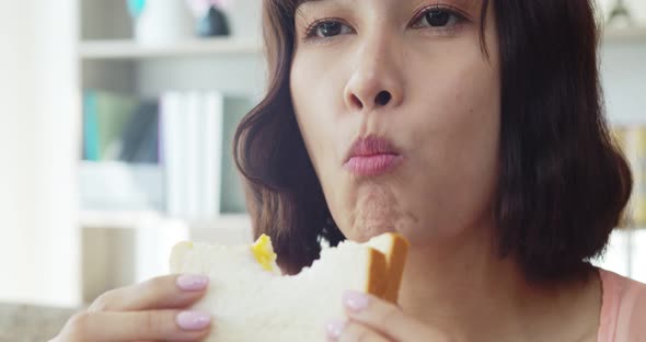 Young woman Biting to eat a big sandwich with delicious