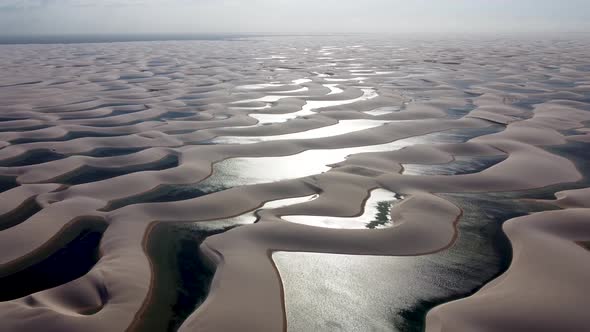 Paradisiac waves scenery of rainwater lakes and sand dunes at Brazil. alt
