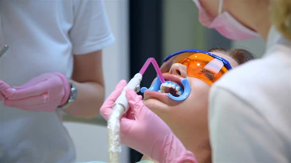 Patient With Protective Glasses For Teeth Whitening Procedure.