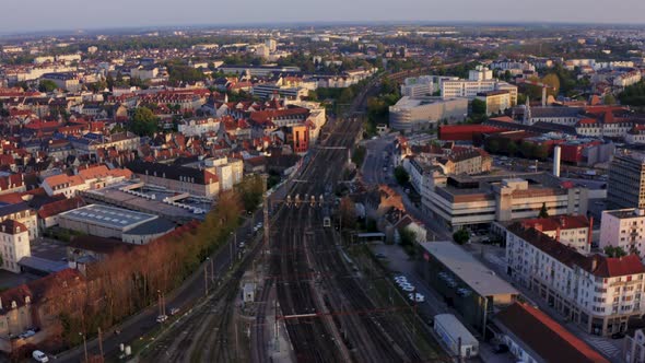 Train on tracks entering city drone tracking shot 4k 30p alt