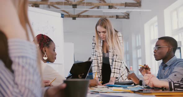 Successful Beautiful Female Leader Listening To Happy Young African American Female Employee at alt