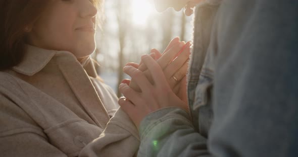 Happy Young Beautiful Couple Spend Time in Sunny Winter Forest Together alt