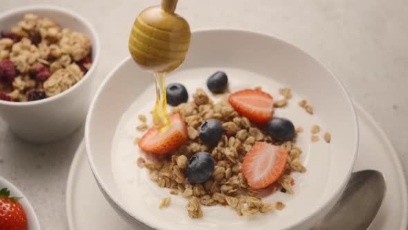 Muesli with yogurt, fresh berries and chocolate sauce