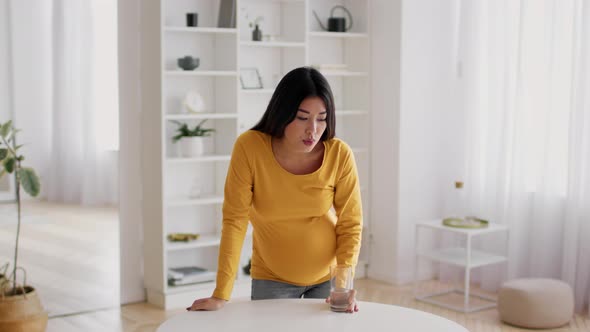 Pregnant Asian Female Suffering Labor Pain Feeling Unwell At Home alt