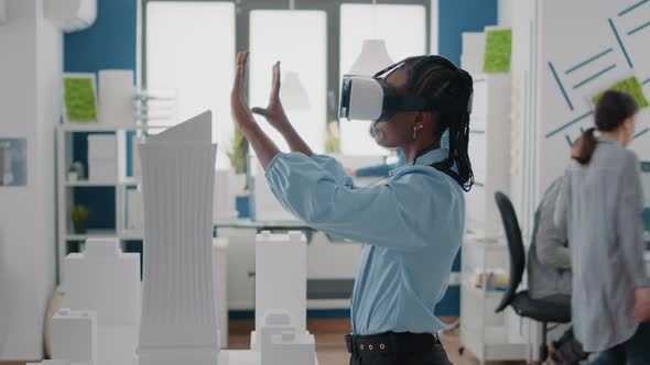 Close Up of Engineer Working with Vr Glasses to Plan Building Model and Architectural Layout alt