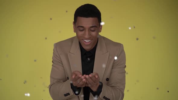 Excited businessman champion guy celebrating winning under confetti rain. alt