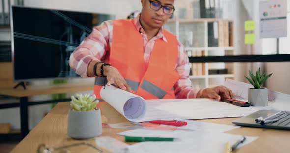 Male Engineer in Vest and Helmet Browsing Paper Project of Future Building alt