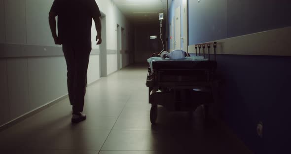 A Hospital Gurney Left After Urgent Patient Stands in Hospital Corridor alt