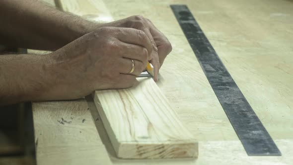 A Man in a Woodworking Workshop Measures the Material with a Ruler Home Workshop Business Furniture