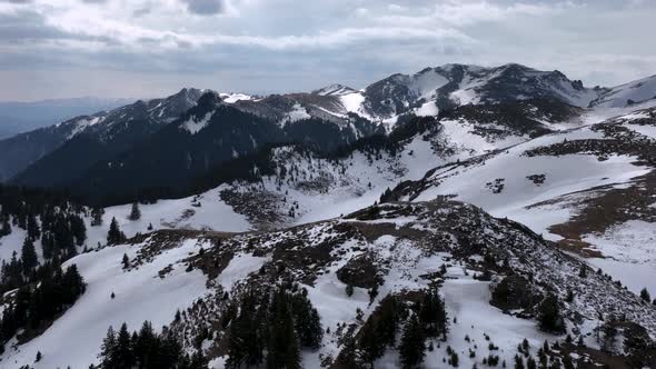 Beautiful Drone View of Romanian Mountains with Ice and Snow in Winter Spring