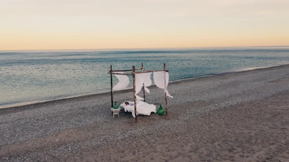 Aerial view gazebo by the sea with girl who enjoy the life alt