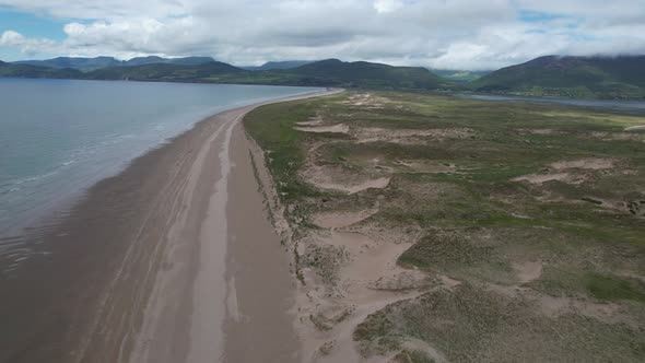 Dramatic Remote deserted Inch beach and sand dunes Dingle peninsula Ireland drone aerial view alt