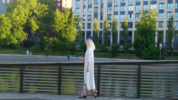 stylish woman walking in the park overlooking the city