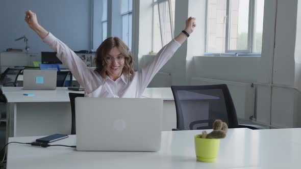 Happy Girl Raises Her Hands Up and Smiling alt