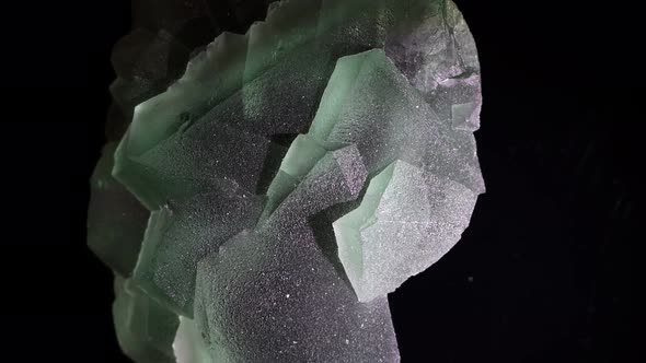 Fluorite crystals show their natural beauty as they shimmer in this unusually large specimen. alt