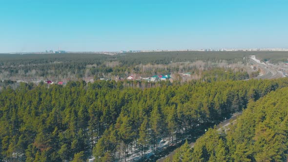 Winding Roads and Pine Forests Surround Cottage Village alt