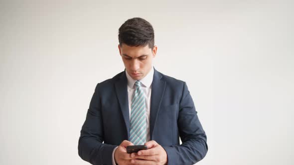 Happy Male Office Worker in Formal Clothes Uses Mobile Phone Rejoices in Victory alt