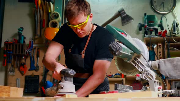 Carpenter Young Working with Wood in Workshop at Night Time Deadline alt