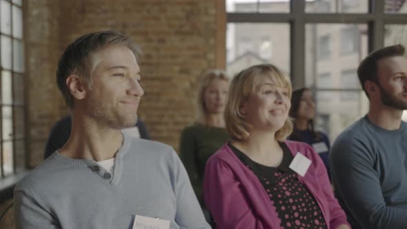 Group adults applauding speaker at event