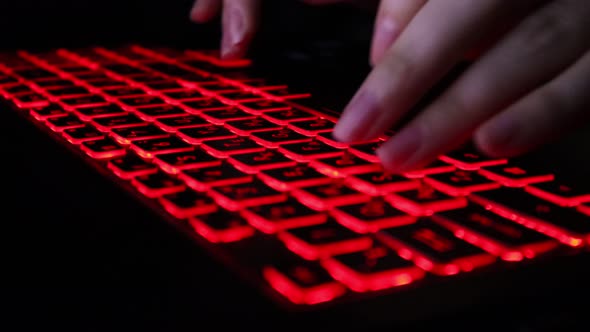 The keyboard is backlit in red. alt