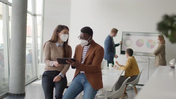 Group of young multiethnic business people working together with facial protection masks