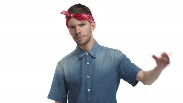 Video of Confident Hiphop Guy with Red Headband Showing Rap Gesture and Looking Sassy Standing Over