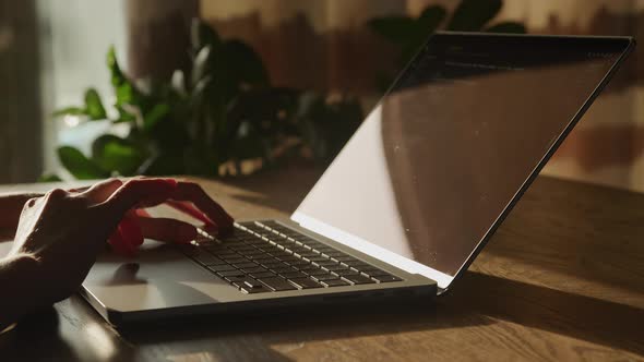 Close Up of a Woman Hand Scrolling on Laptop Touchpad While Reviewing Code alt