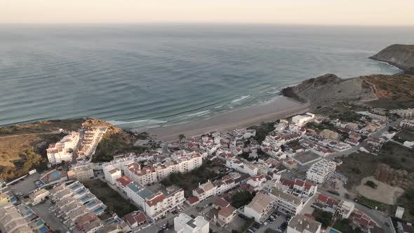 Picturesque seaside town of Burgau, Algarve. Panoramic aerial view beach and ocean alt