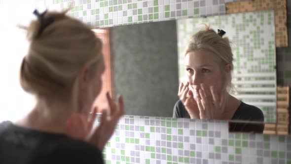 Mature woman looking in the mirror