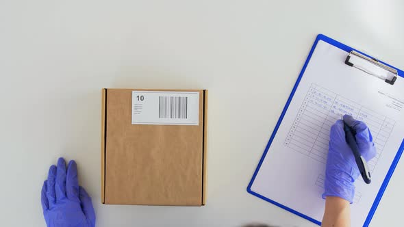 Hands in Gloves with Parcel Box and Clipboard alt