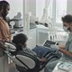 Dentist Showing X-ray to Boy and Woman - VideoHive Item for Sale