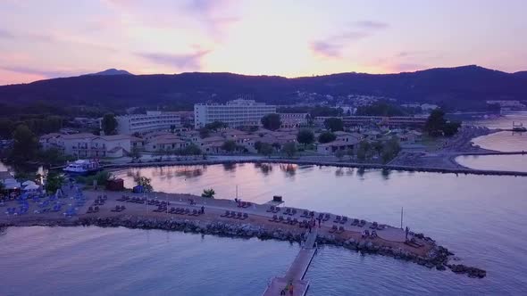 Greece, Corfu Island, drone footage of a beautiful sunset over Messonghi Beach. Orbit Shot Right. alt