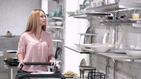 The Pretty Housewife Is Choosing China Crockery at the Kitchen Ware Store alt