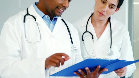 Two doctors discussing with the clipboard alt