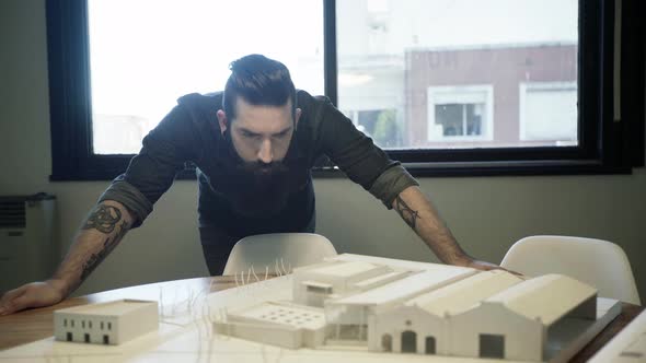 Architect examining architectural model