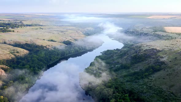 Dense Fog Morning Clouds Above the Riverbed alt