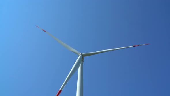 Wind turbine generating electricity on blue sky, sustainable development, renewable energy
