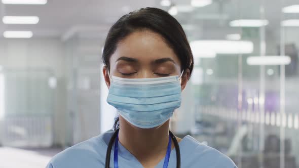 Portrait of female doctor wearing face mask in hospital alt