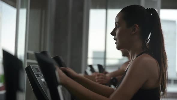 athlete people exercise and training at sport gym, fitness workout with bicycle equipment alt