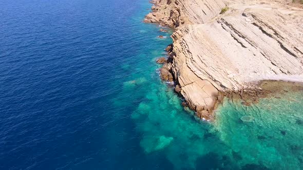 Clear Sea Water of the Promontory Headland Surrounded by Stone and Rocky Coastline alt