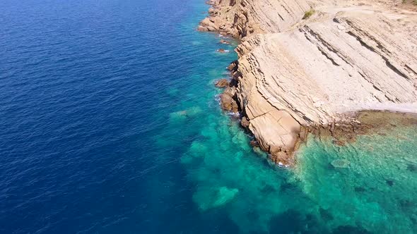 Clear Sea Water of the Promontory Headland Surrounded by Stone and Rocky Coastline